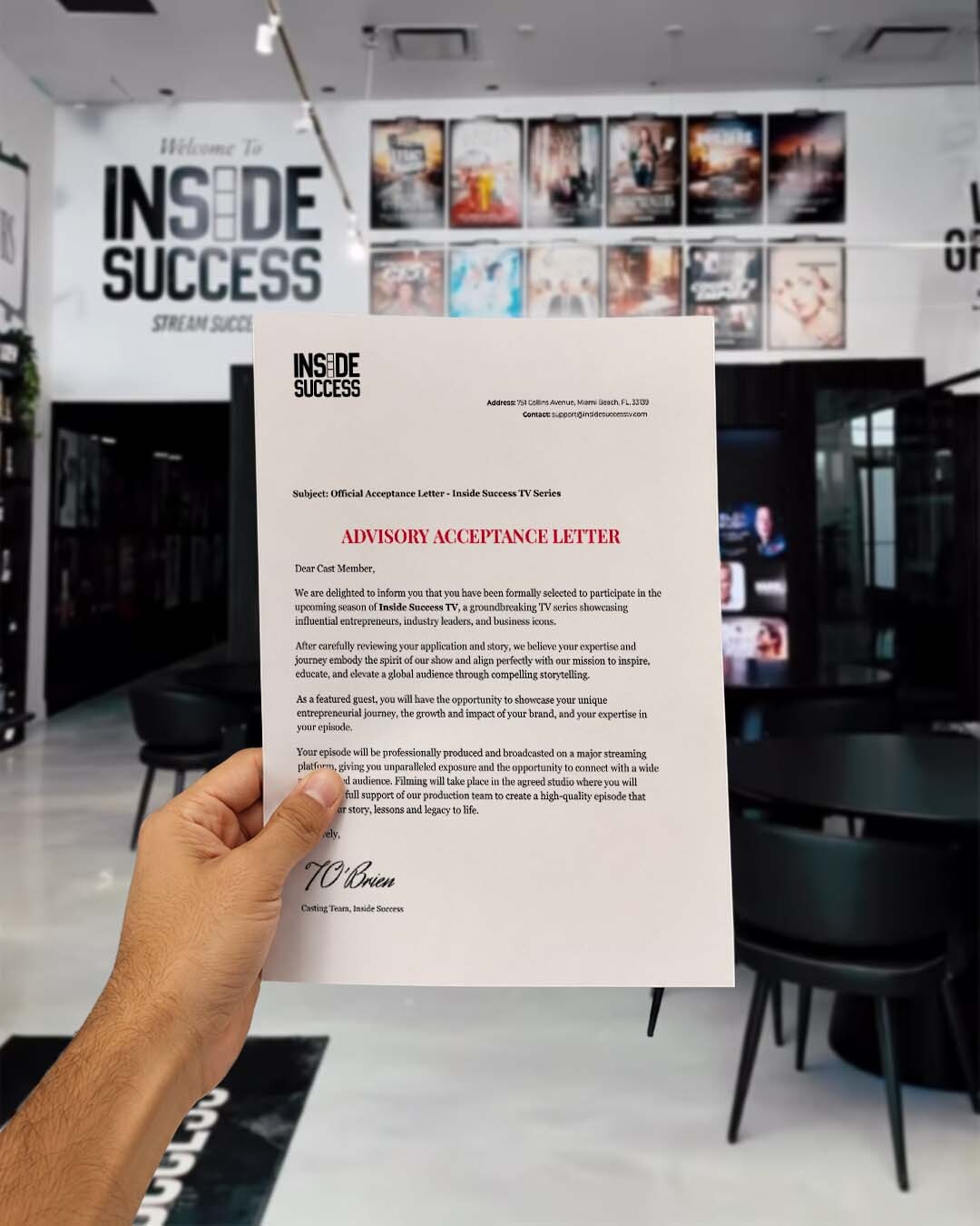 Official Inside Success TV acceptance letter held inside the Inside Success studio in Miami